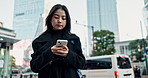 Outdoor, city and Japanese woman with a smartphone, typing and internet with social media, social media and mobile user. Person, outside or girl with cellphone, digital app or Hiroshima with internet