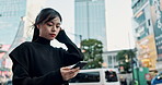 Japanese woman in city, reading phone and social media with internet connection on morning commute. Search, schedule and travel, Asian girl in street checking email or post on smartphone in Tokyo.