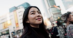 Happy, thinking and a Japanese woman in the city for commute, tourism or weekend. Smile, travel and a walking girl in town with an idea for vacation, holiday or a trip in Japan for sightseeing