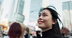 Japanese woman, happy and walking in city for travel and relax wellness or leisure in outdoor. Young person, smile or tokyo as advertising professional by corporate cityscape or excited in urban town