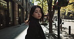 Japanese woman, face and happy or walking in city, travel and leisure in outdoor environment. Young person, smile or portrait in tokyo on sidewalk, relax wellness or journey in sunshine in urban town