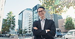 Japanese businessman, face and arms crossed in town, glasses and smile with positive in corporate career. Young person, portrait and entrepreneur as confident for vision and formal suit in outdoor