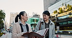 Business people, Japan and women with documents, walking and conversation with planning, cooperation and discussion. Hiroshima, manager and employee with teamwork, coworkers and collaboration