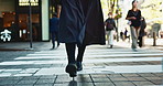 Feet, walking and woman in the busy city with bag for work with travel in street with people. Legs, closeup and back zoom of female person commuting to job or career at workplace in urban town road.