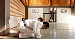 Black belt, students or bow in dojo for aikido practice, discipline or self defense for respect. Combat demonstration, Japanese people learning or ready to start training for fighting class education