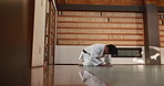 Man, student and bowing for aikido in dojo with greeting for respect, tradition and culture in class. Martial arts, person and sitting for discipline, worship or expression in practice with fitness