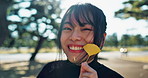 Asian, happy woman in park and leaf with face and explore nature for wellness and outdoor environment. Sunshine, plants and portrait, travel and adventure in public garden with smile on journey