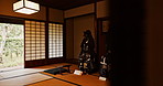 Japan, Samurai suit and wood furniture in living room with retro and Japanese armor with screen door. Minimal, zen decor and wooden counter with tatami mat and carpet with interior design isolated 
