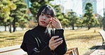 Asian woman, selfie and relax on park bench for photography, picture or outdoor memory. Young attractive female person moving hair and sitting for photo, photograph or social media in nature outside