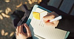 Person, hands and writing in diary on park bench for reminder, agenda or memory in nature above. Top view and closeup of writer or journalist taking notes in book or notebook with pen for planning