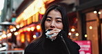 Travel, eating and Asian woman with onigiri in the city on exploring vacation, adventure or holiday.Portrait, food and young female person enjoying a Japanese snack or meal in town on weekend trip.