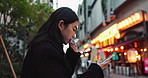 Phone, eating and Asian woman with onigiri in the city on exploring vacation, adventure or holiday. Hungry, food and young female person enjoying a Japanese snack or meal in town on weekend trip.