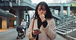 Asian woman, phone and walking while eating muffin in city for funny joke, communication or social media. Female person strolling on mobile smartphone and biting desert or cupcake in an urban town