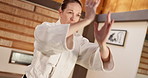 Exercise, aikido or woman learning martial arts in dojo for practice, body movement or self defense. Combat routine, wellness or female person in training workout for fighting, education or class