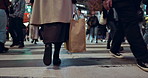 Feet, walking and woman in the busy city with bag for work with travel in street with people. Legs, closeup and back zoom of female person commuting to job or career at workplace in urban town road.