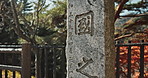 Japan, stone and Asian sign for history, ancient culture and tomb with spiritual rock with Japanese marble. Grave, religion and tombstone with statue for zen and respect on a urban street in Kyoto