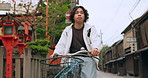 Bicycle, travel and man riding in the city for exercise or transportation to college academy. Fitness, backpack and young male student driving a bike to university for carbon footprint in urban town.