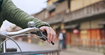 Hands, bicycle and brake handle in street, travel and transport outdoor of active rider on urban road for health. Closeup, press handlebar and person cycling to control or check bike in Kyoto Japan