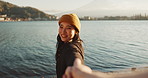 Happy, face and a couple holding hands at the beach for love, date or travel together for holiday. Nature, walking and portrait of a Japanese girl with a smile and leading a person to water or a lake