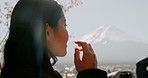 Japanese woman, thinking and nature for mountain, travel and outdoor on vacation, trip or journey. Girl, person and holiday by Mt Fuji with vision, memory or ideas in closeup, environment and trees