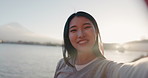 Japanese woman, selfie and happy outdoor, pointing at lake or river for social media and travel influencer in nature.  Live streaming, adventure and wave at camera in Japan with smile in portrait