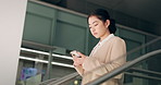 Japanese, escalator and travel with businesswoman, phone or social media with internet, employee or convention. Person, consultant or worker with airport, communication or connection with mobile app