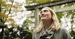 Woman, nature and torii gate in Kyoto with wow, mindfulness and travel with spiritual history. Architecture, japanese culture and shinto shrine in woods with sculpture, memorial and monument