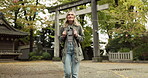 Woman, nature and torii gate in Kyoto with wow, surprised and travel with spiritual history. Architecture, japanese culture and shinto shrine in woods with sculpture, memorial and monument landscape