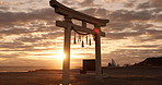 Torii gate, sunset sky and beach in Japan with clouds, zen and spiritual history on travel adventure. Shinto architecture, Asian culture and calm nature on Japanese landscape with sacred monument.