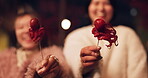 Woman, Japan and traditional street food at night or octopus delicacy, travel or experience. Female people, face and snack on stick for tourism eating cuisine in town for taste, dinner or holiday