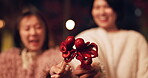 Women, Japan and travel street food at night for octopus delicacy, culture or traditional. Female people, snack and stick for tourism eating experience or cuisine in town for taste, dinner or holiday