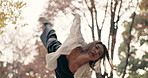 Japanese woman, trees and dancing in park, moving body and freedom for street performance in nature. Girl, dancer and person with art, concert and steps with creativity, face and balance in Tokyo