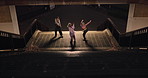 Women, group and dancing on stairs in city, moving body and freedom for street performance in night. Team, dancer or people with art, concert and steps with creativity, vision and balance in Tokyo