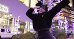 Woman in Japan, dancing in city at night with energy and fun, happiness and freedom outdoor. Celebration, party and music with Japanese dancer on urban street, light and positivity for nightlife