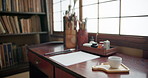 Art, sketch paper and calligraphy tools at desk with creative brushes, pencil and ink for illustration. Japanese sumi, document and home isolated with drawing, creation and creativity for painting