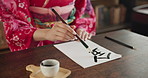 Paintbrush, ink and hands, Asian script and writing with paper, document and creativity, calligraphy and traditional text. Japanese font, writer with black paint and person at desk with art and tools