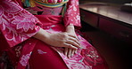 Hands, woman and traditional Japanese clothes for Shinto religion with color, fabric and style in room. Person, pink dress and culture for zen, balance or mindfulness with sitting with peace in Tokyo