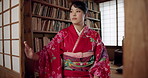 Japanese woman, door and traditional clothes in library with vision, ideas or remember for studying religion. Girl, person and thinking by bookshelf, memory or mindfulness for spiritual development