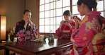 Friends, teapot and happy Asian women with tea for culture with cup, leaves and herbs in home. Traditional, ceremony and people with herbal beverage for relax, detox and wellness for drinking ritual