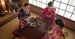 Friends, teapot and Asian women with tea for culture with cup, leaves and herbs in home. Traditional, ceremony and people with herbal beverage for relaxing, detox and wellness for drinking ritual