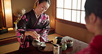 Herbs, teapot and Asian women with tea for culture with traditional leaves and wellness in home. Friends, ceremony and people with herbal beverage for relaxing, calm and detox for drinking ritual