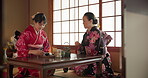 Women, Japanese and tea ceremony in traditional tatami room for healing ritual, harmony or calm environment. Female people, kimono dress and hot drink for connection, religious experience or health