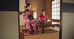 Japanese women, traditional tea ceremony and friends with respect, kindness and relax with bow at table. Girl, people and together for drink, matcha or indigenous clothes with cup, culture and home