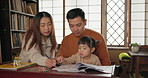 Happy, family and girl with homework, education and Japan with activity, writing and studying. Parents, mother and father with a kid, book or child development with fun, learning and bonding together