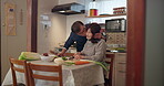 Japanese couple, kiss and cooking in kitchen in home, cuisine and care together with cutting vegetables. Mature woman, man and supper with romantic by nutrition meal, dinner and apartment for soup