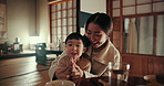 Asian mom, child and pray at dinner with smile, learning or teaching gratitude with care, night of nutrition in home. Faith, mother and daughter for food, diet or dining room at family house in Tokyo