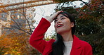 Outdoor, thinking and Japanese woman with a smile, park and journey with vacation, daydreaming and wonder. View, outside and person with nature, relax or freedom with wellness, holiday and adventure
