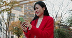 Japanese woman, city and laugh with phone for reading funny notification, social media post and download digital app. Happy lady scroll on smartphone for meme, chat and joke in urban park in Tokyo 