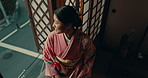 Thinking, relax and traditional Asian woman with smile for reflection, calm and wellness in morning. Kimono, culture and person in home with view for thoughtful, wondering and happy in living room