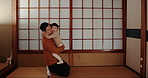 Smile, hugging and Asian father with child bonding with care, sweet and cute relationship. Bow, culture and happy young dad greeting and embracing girl kid with love in traditional dojo or studio.
